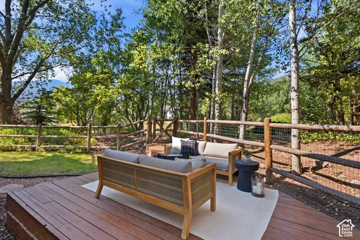 Secluded and private back deck right off the kitchen and dining room with multiple seating areas for entertaining, relaxing, working from home, and being immersed in nature.  The home often sees moose, deer, rabbits, squirrels, birds and less commonly elk