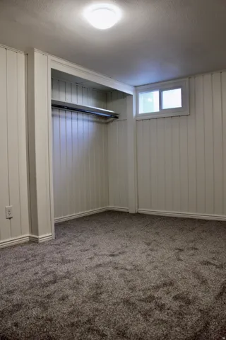 Carpeted flooring, built-in closet, flush mount ceiling light, and window