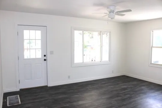Crisp white walls with wood-finish flooring