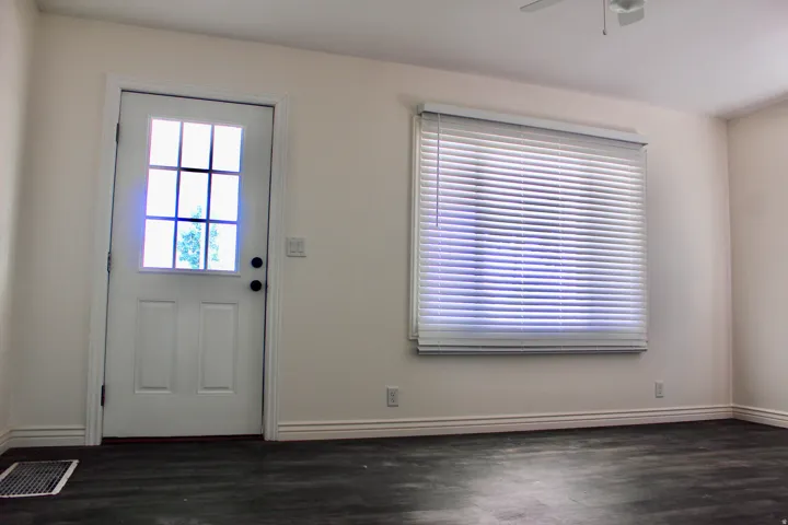 Recessed lighting, wood-finish flooring, white door with glass panels, window with blinds, ceiling fan