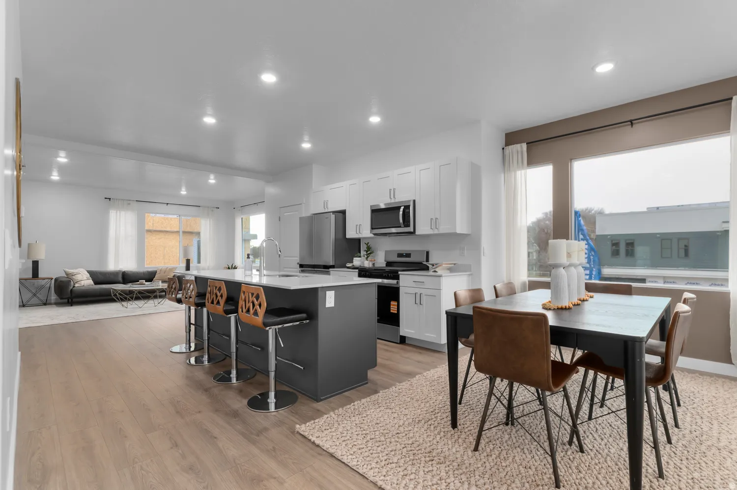 Open-concept living space featuring wood-finish flooring and recessed lighting