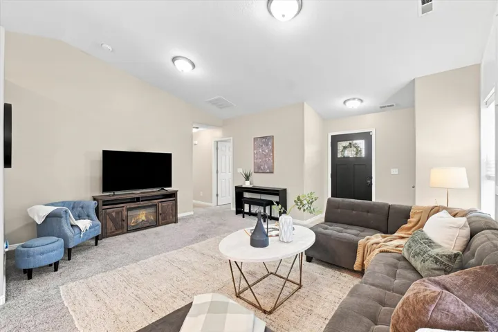 Spacious primary living area featuring recessed ceiling lights, neutral wall finishes, and engineered wood-finish flooring throughout