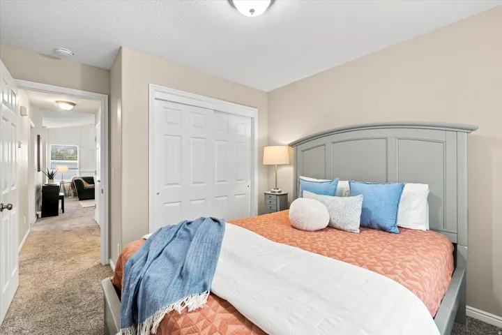 Neutral wall paint, plush carpeting, bi-fold closet doors, and recessed lighting