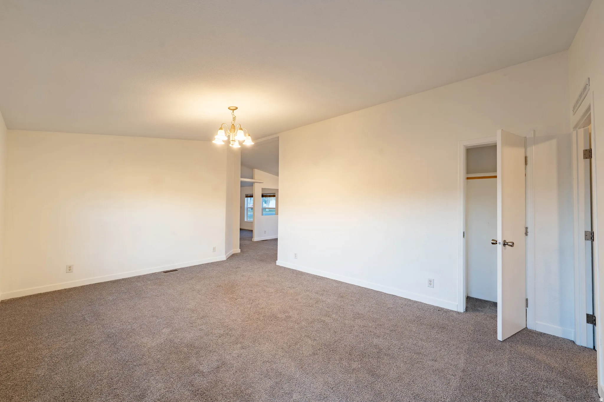 Recessed lighting, neutral-toned walls, and carpeted flooring