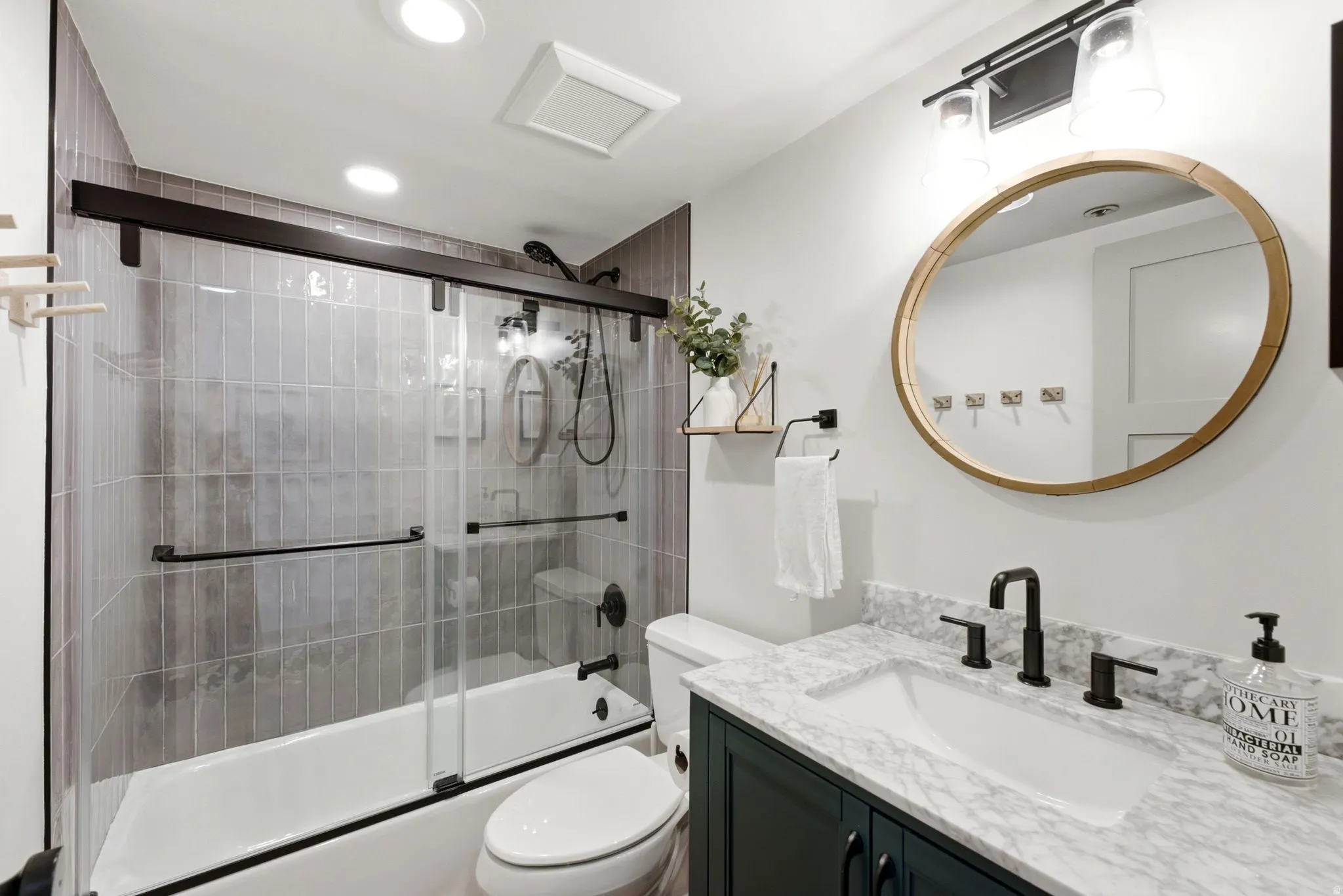 Vanity with a white undermount sink and dark countertop