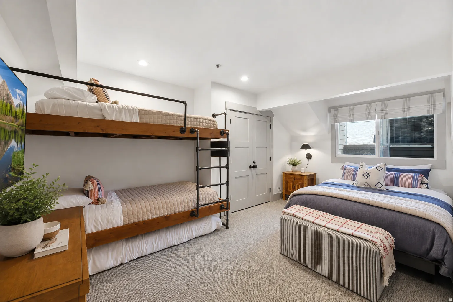 Interior bedroom featuring bunk beds with metal safety rails and a separate bed frame