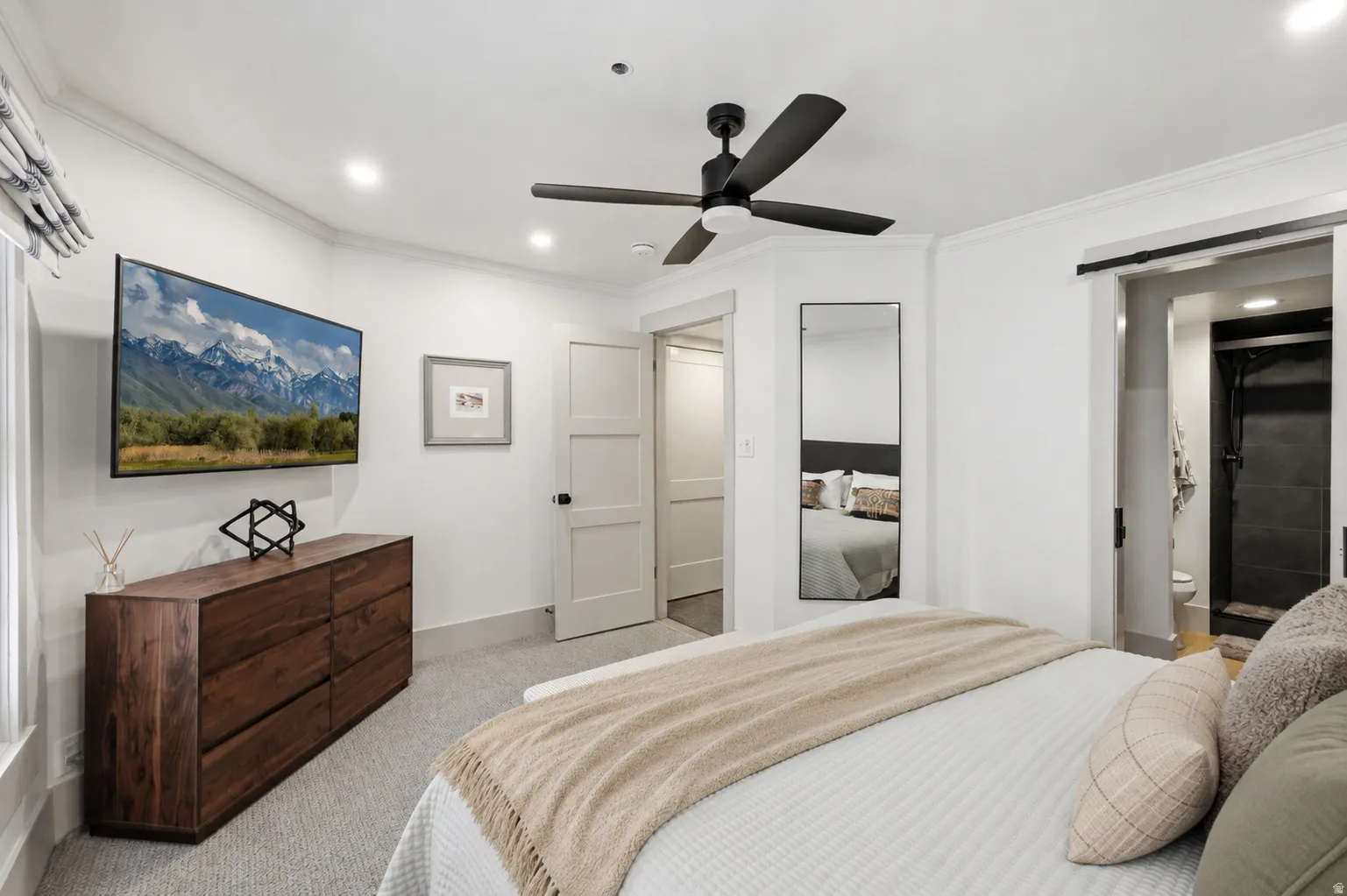 Recessed lighting, crown molding, and a ceiling fan with integrated lighting