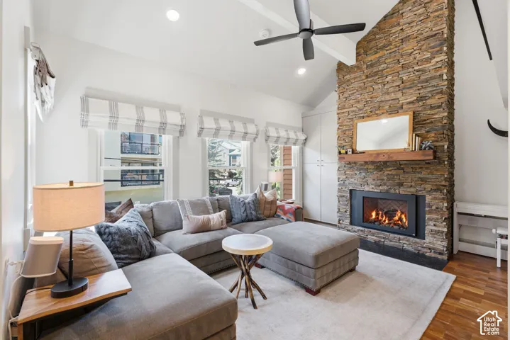 Vaulted ceilings and recessed lighting complement the stacked stone fireplace with a wood-finish mantel