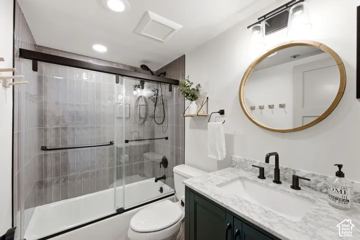 Vanity with a white undermount sink and dark countertop