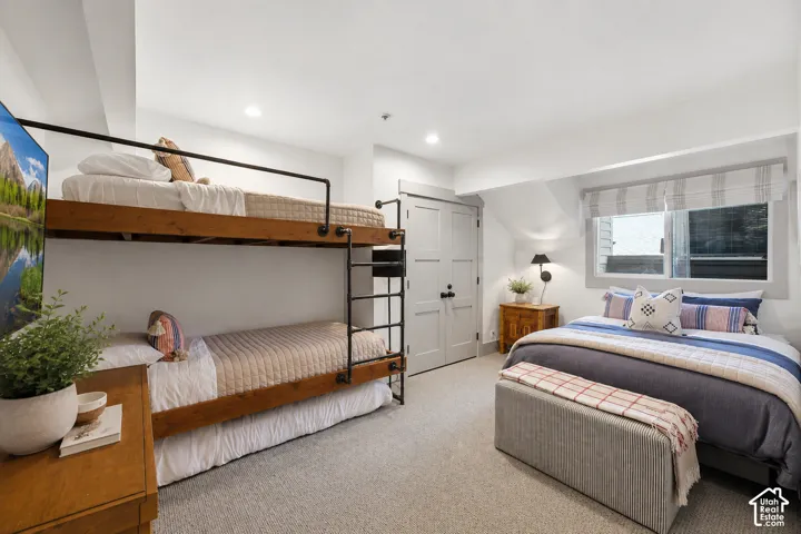 Interior bedroom featuring bunk beds with metal safety rails and a separate bed frame