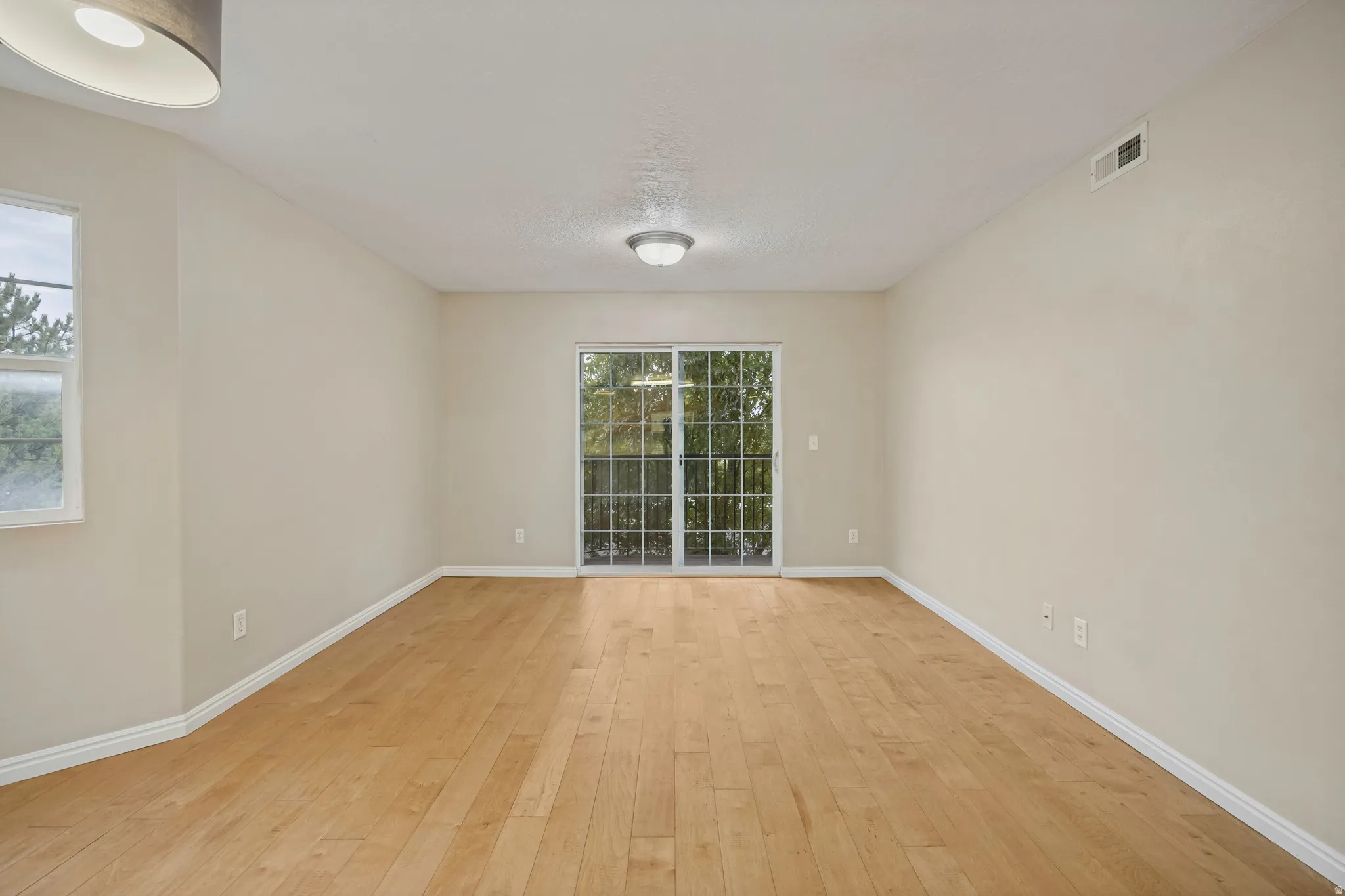 Wood-finish flooring throughout, light neutral wall paint, and white trim