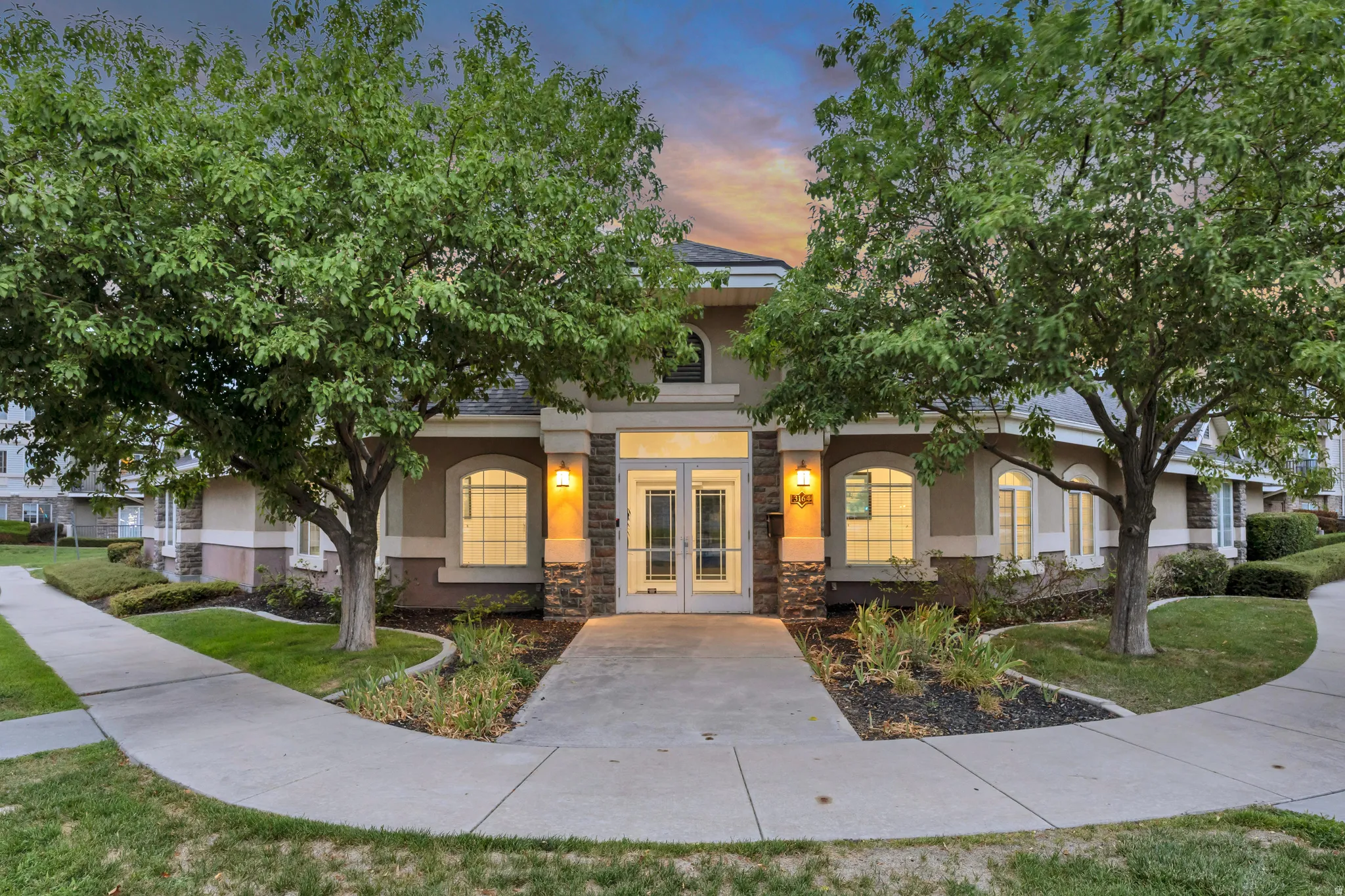 Two-story building exterior with stucco finish and stone accents