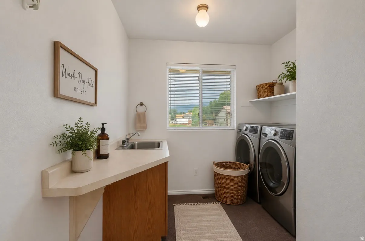 Dedicated laundry area with a utility sink, countertop space, and built-in shelving
