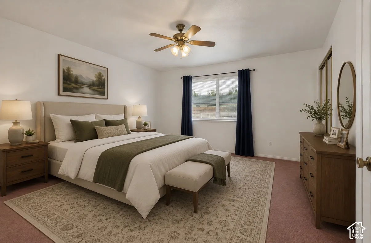 Spacious primary bedroom with white walls, a ceiling fan with integrated lighting, and a double window with dark drapery