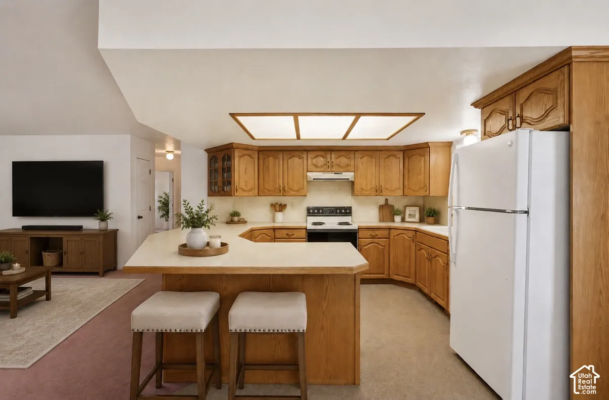 Open-concept kitchen featuring wood cabinetry and a U-shaped peninsula with countertop seating
