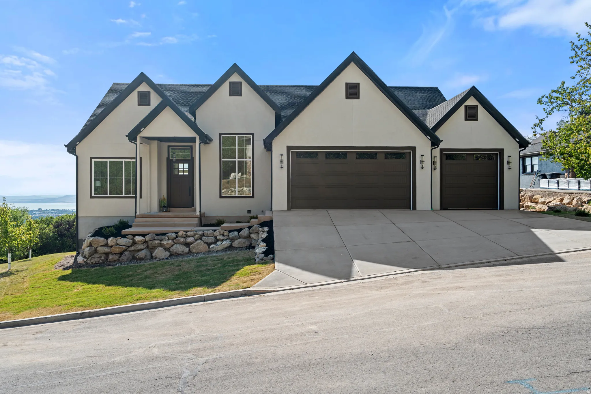 Contemporary exterior with light-toned stucco and dark trim accents