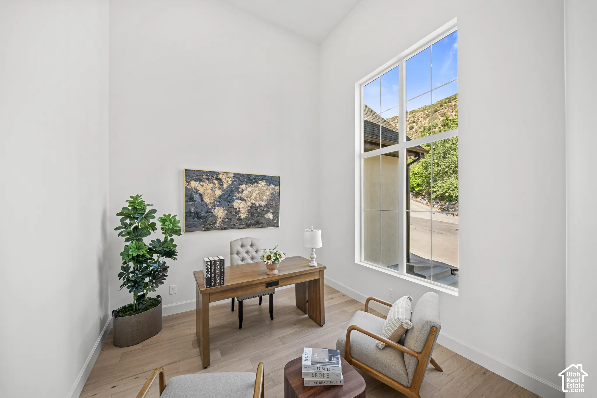 High ceilings and light wood-finish flooring