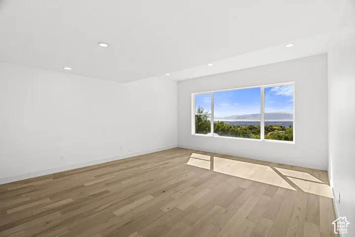 Expansive window providing a distant landscape with mountains and trees