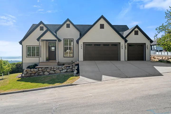 Contemporary exterior with light-toned stucco and dark trim accents