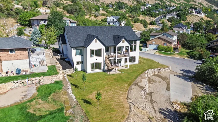 Contemporary exterior with dark shingle roof, white siding, and black trim accents