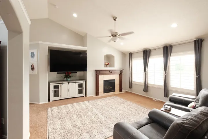 Vaulted ceiling with recessed lighting and ceiling fan