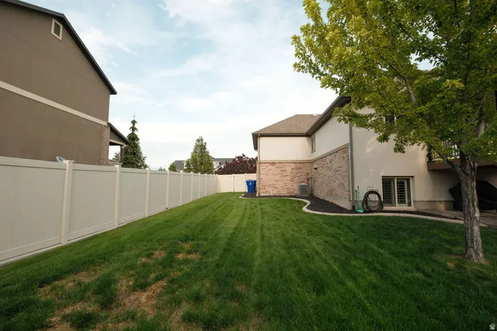 Expansive lawn with a full vinyl privacy fence