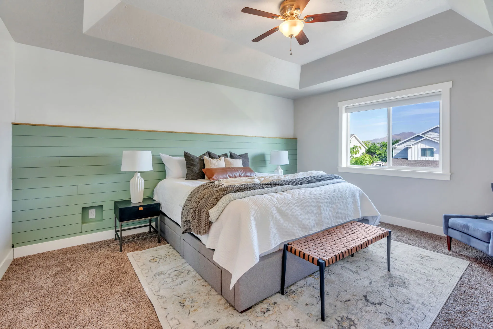 Master bedroom with tray ceiling and feature wall