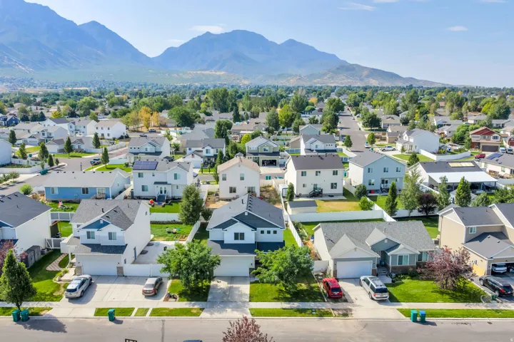 Mountain backdrop, residential neighborhood, paved streets, manicured lawns, two-story homes