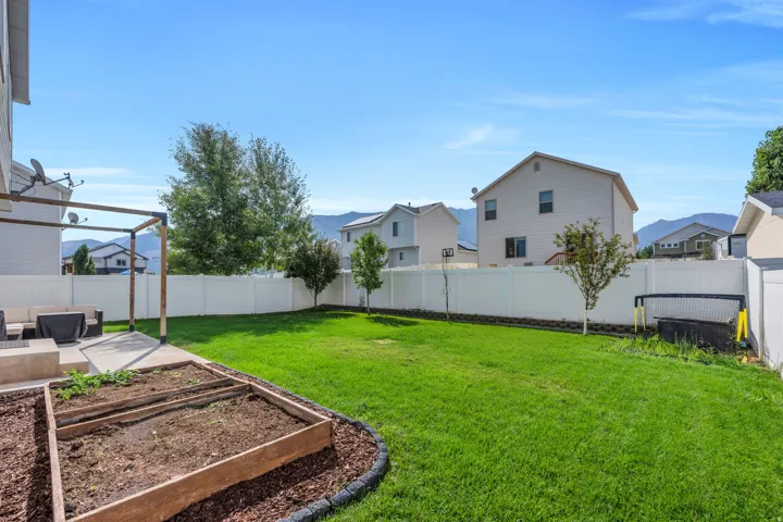 Finished yard with garden beds and auto sprinkler system