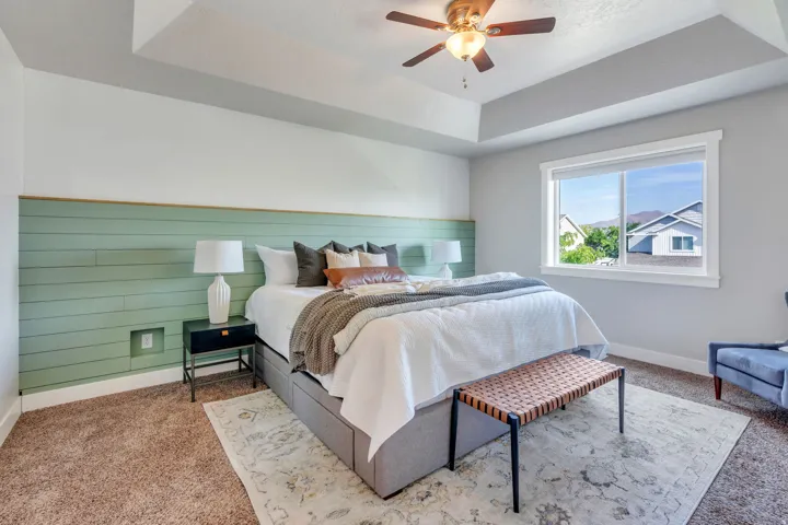 Master bedroom with tray ceiling and feature wall