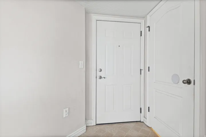 White paneled door with brushed nickel hardware
