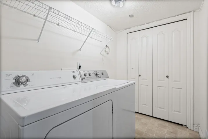 Utility area featuring wire shelving, bi-fold closet doors, and tile flooring