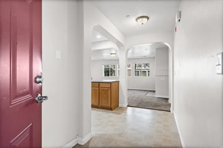 Arched doorways, overhead lighting, and resilient flooring