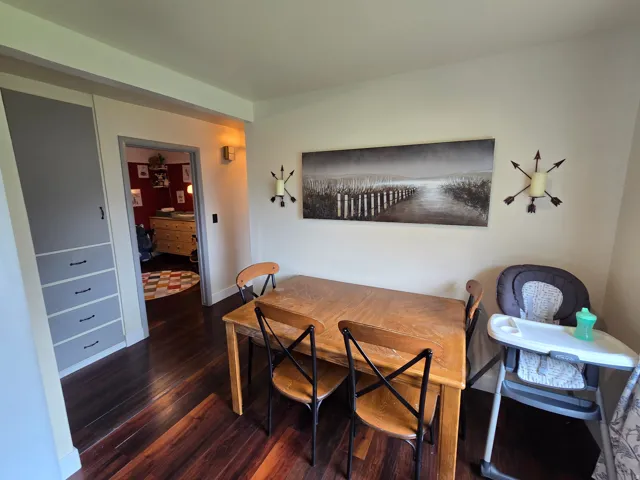 Wood-finish flooring, built-in cabinetry, and wall sconces