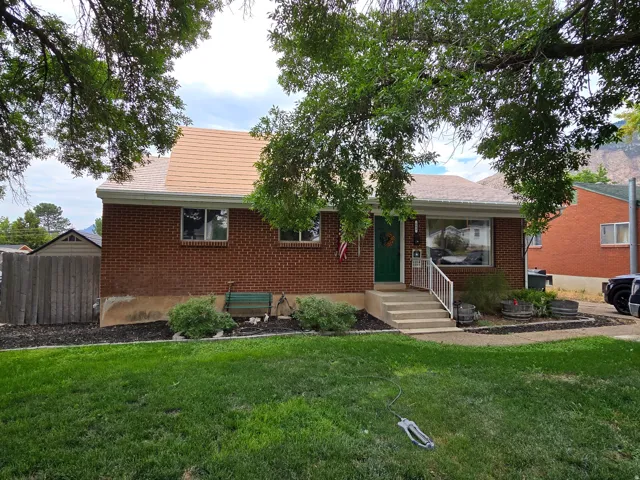 Brick exterior with a new roof and a green front door