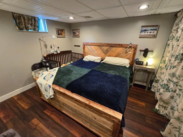 Wood-finish flooring, recessed lighting, and a window with a valance