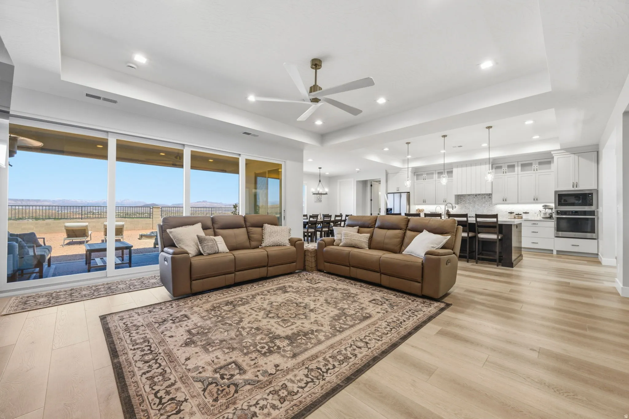 Expansive great room with LVP wood finish flooring, recessed lighting, and a ceiling fan
