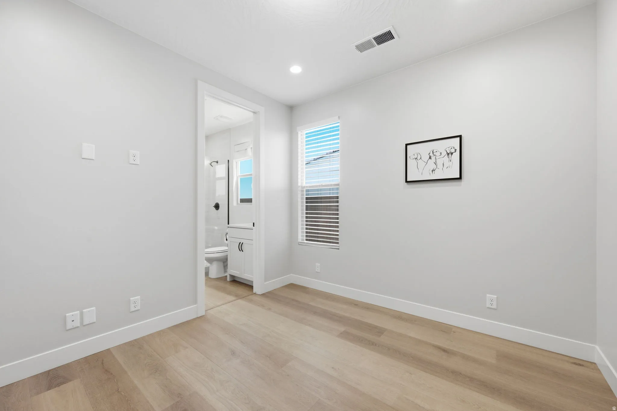 Recessed lighting, LVP wood-finish flooring, and a window with horizontal blinds
