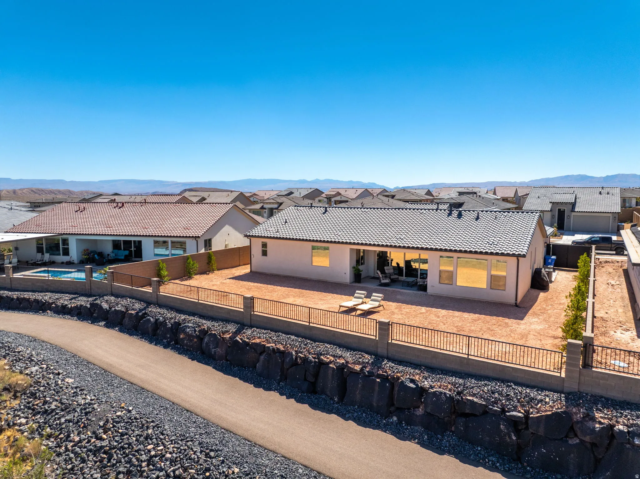 Rear exterior featuring a patio, 16' sliding glass doors, and walking trail
