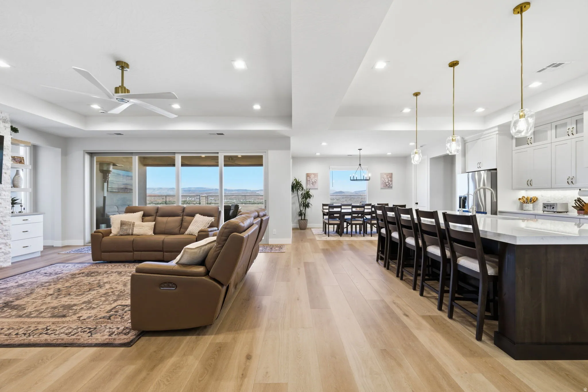 Open concept design featuring LVP wood-finish flooring, recessed lighting, and a kitchen island with pendant lighting
