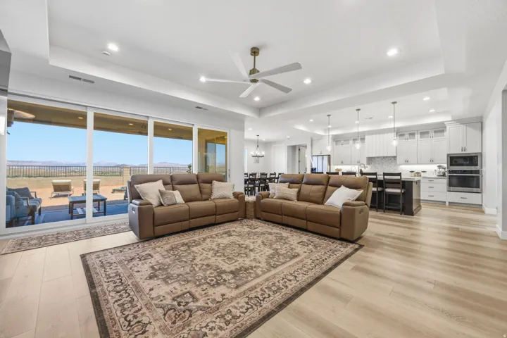 Expansive great room with LVP wood finish flooring, recessed lighting, and a ceiling fan