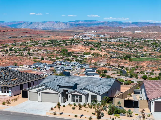Contemporary exterior with a 3-car garage, low-maintenance landscaping, and a tile roof