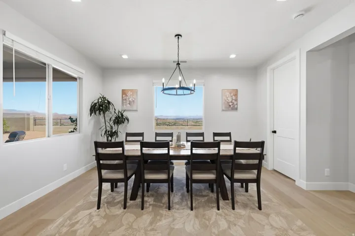 Expansive dining area featuring multiple windows, LVP wood-finish flooring, and recessed lighting