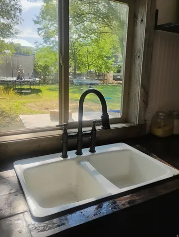 Double basin sink with dark bronze faucet