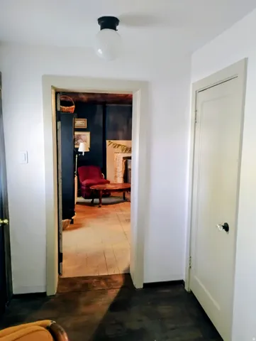 White interior walls with a flush-mount ceiling light