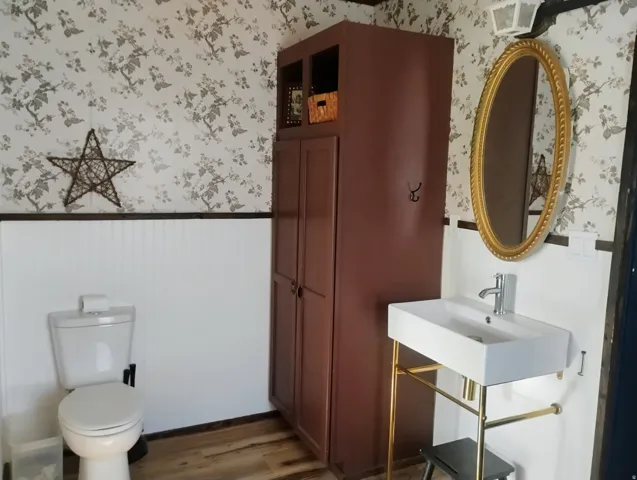 White beadboard paneling with floral wallpaper accent