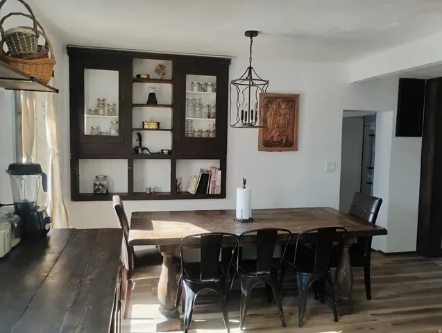 Built-in dark wood cabinetry with glass fronts and open shelving