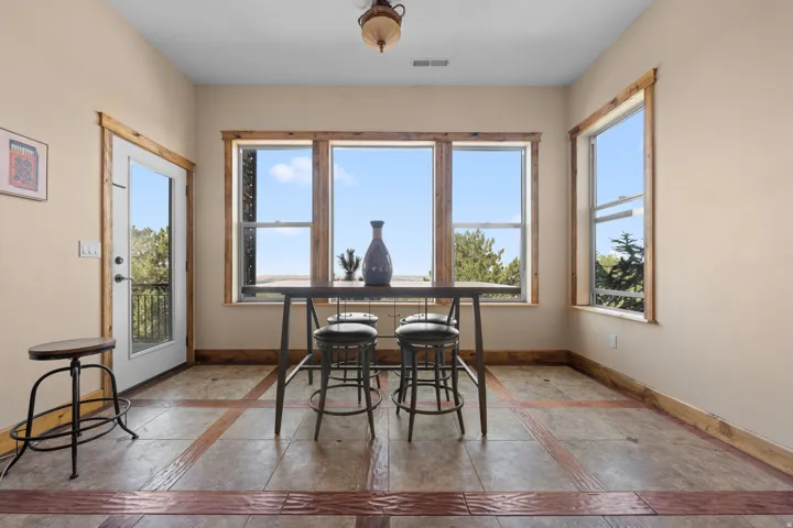 Light-toned walls with wood trim throughout, transom windows, and a glass-paneled exterior door