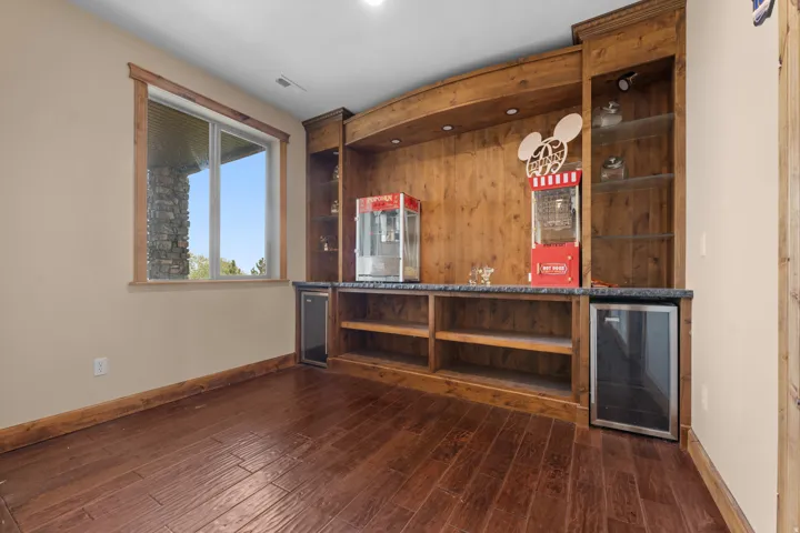 Built-in entertainment center featuring wood-finish cabinetry, integrated shelving, and a beverage cooler