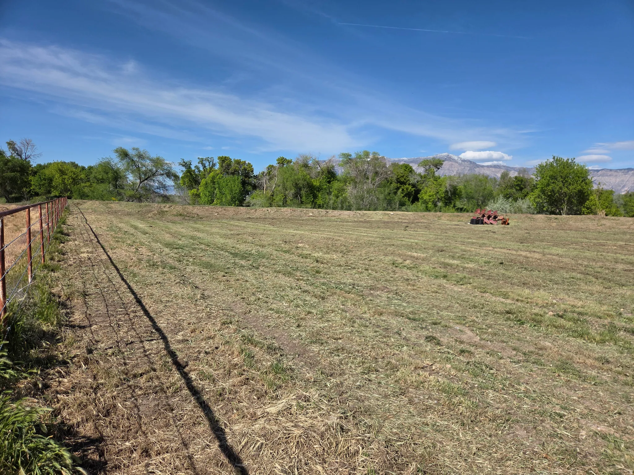 Expansive open field with a wire fence boundary